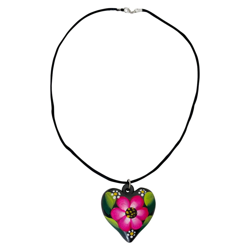 Oaxacan Black Clay hand-sculpted heart-shaped necklace with painted floral details in magenta